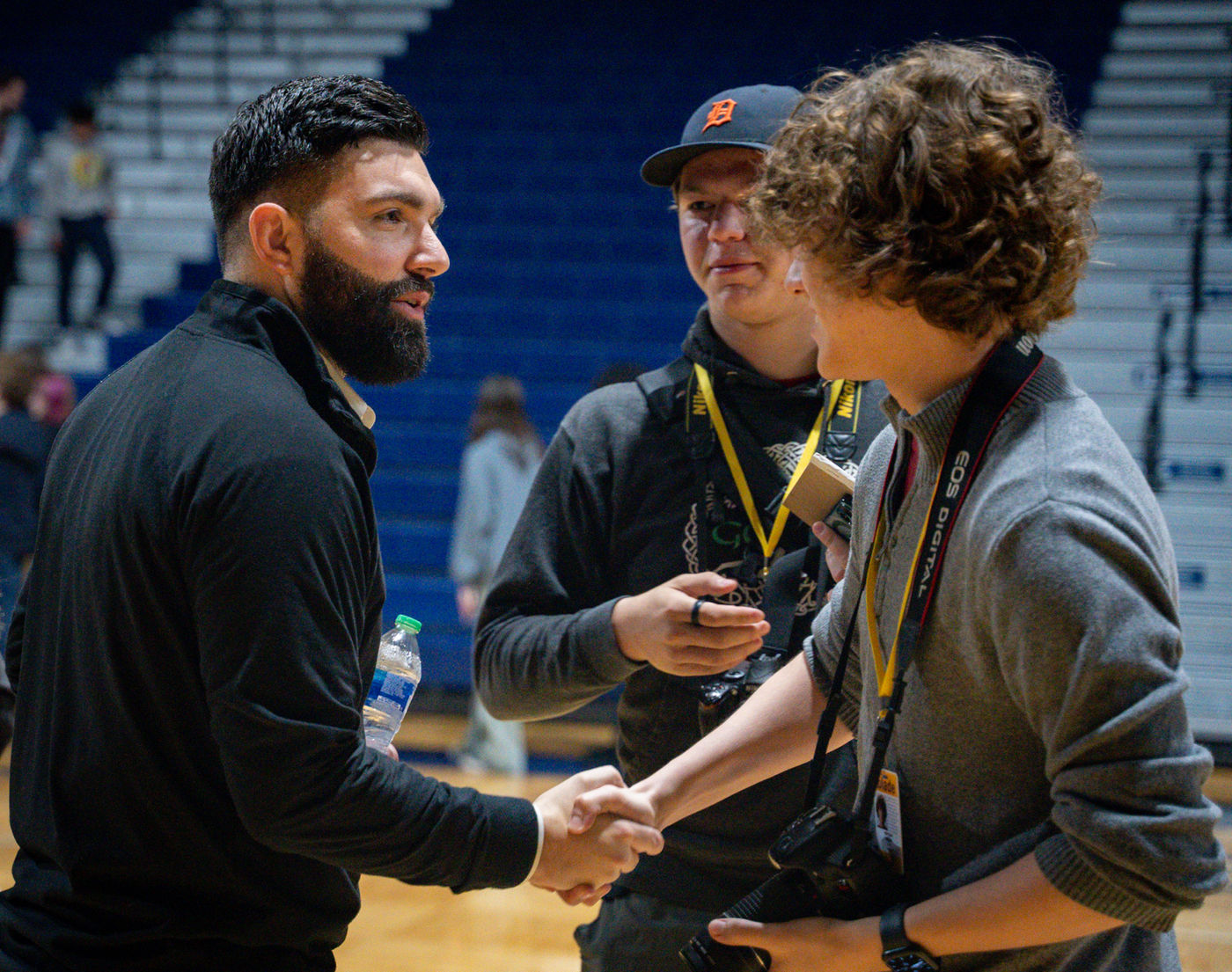 A Youniversal Learning team member greeting a student at an event